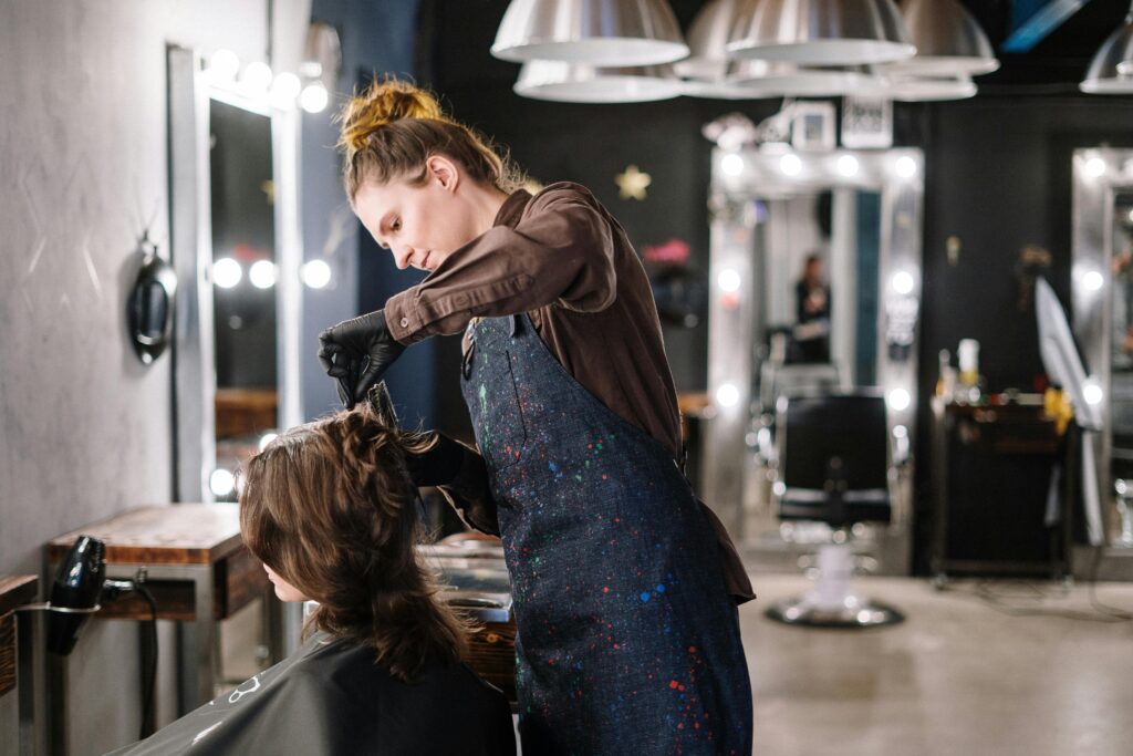 Professional hair stylist working on a client's hair in a modern salon